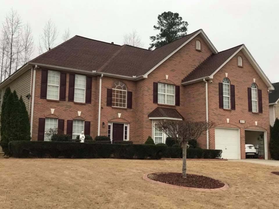 Two-story brick home with a finished new roof